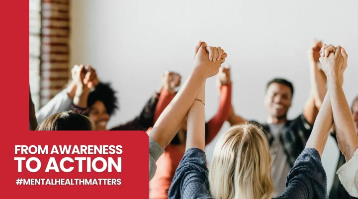 A diverse group of people standing in a circle, holding hands with their arms raised high in a gesture of unity and solidarity. A red graphic overlay on the left reads 'FROM AWARENESS TO ACTION' followed by the hashtag '#MENTALHEALTHMATTERS'.